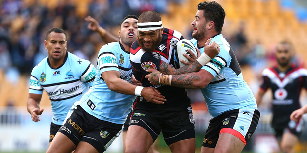 Manu Vatuvei of the Warriors looks to beat the tackle of Andrew Fifita, right, and Tupou Sopoaga of the Sharks. Photo / Simon Watts / Getty Images