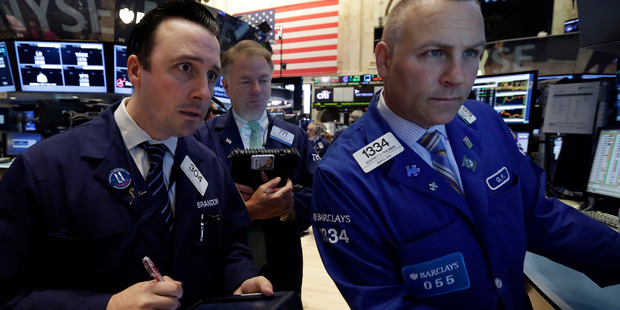 Specialist Geoffrey Friedman, right, works with traders on the floor of the New York Stock Exchange. File photo / AP
