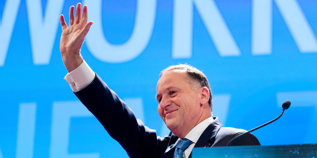 Prime Minister John Key waves to supporters. Photo / Mark Mitchell