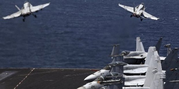 Fighter jets leave a US aircraft carrier in the Persian Gulf for a mission in Iraq. Photo / AP