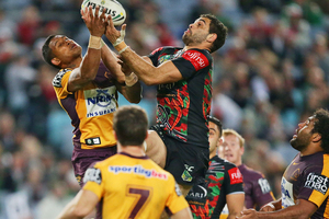 Greg Inglis of the Rabbitohs beats Ben Barba of the Broncos for a high ball before setting up the try to Luke Keary. Photo / Getty Images