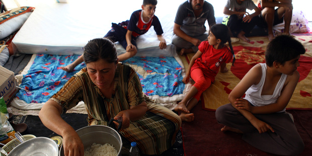 Iraqi Yezidi woman prepares food for the family. Photo / Getty Images