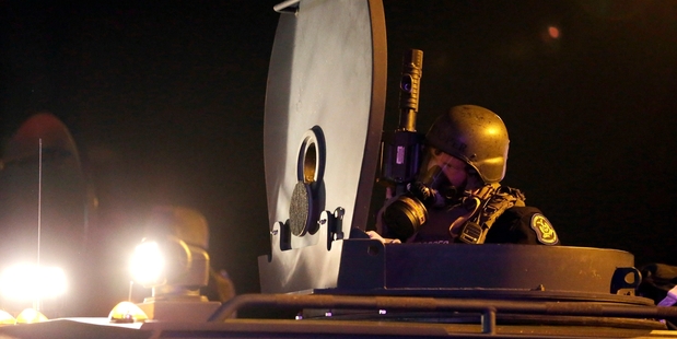 Police and troops are patrolling the streets of Ferguson in armoured vehicles. Photo / AP