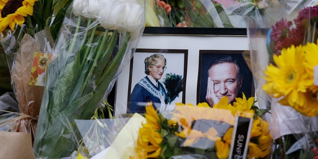 Fans have left flowers at a makeshift memorial in San Francisco unaware Robin Williams' funeral has been held. Photo / AP