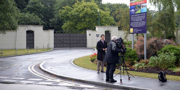 Members of the media report from outside the Charters Estate, in Berkshire, England, where British singer Cliff Richard has an apartment. Photo / AP