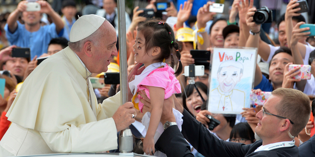 Pope Francis, left, blesses a child upon his arrival for the Closing Holy Mass of the 6th Asian Youth Day in Haemi, south of Seoul, South Korea. Photo / AP