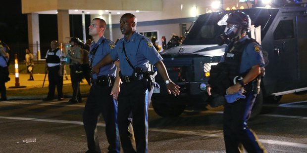 Captain Ron Johnson, center, pulls his men back during protests in Ferguson. Photo / AP
