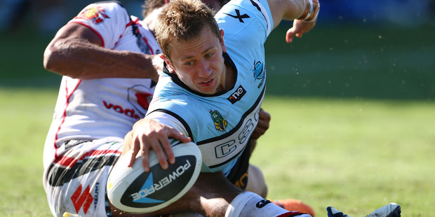 Nathan Stapleton of the Sharks scores a try in the tackle of Dane Nielsen during the round five NRL match. Photo / Getty Images