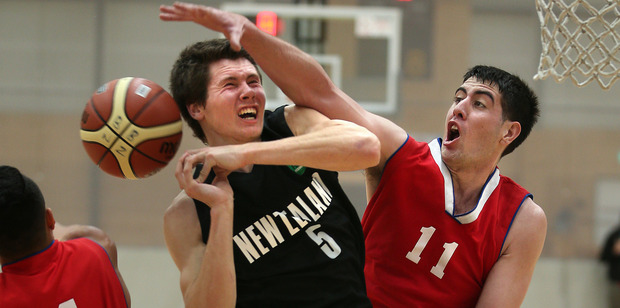 Junior Tall Blacks player Dane Brooks blocked by Porirua's Jordan Ngatai. Photo / John Borren