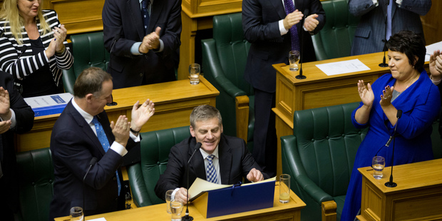Finance Minister Bill English is congratulated by Prime Minister John Key and colleagues after reading his 2014 Budget. Photo / Mark Mitchell