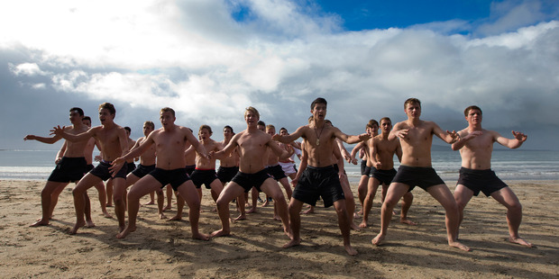 The Westlake Boys High School First XV rugby team perform a haka before taking a midwinter swim at Takapuna Beach. Photo / Brett Phibbs