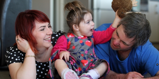 Ariana Lawn plays with her parents, Cerise and Tim, at their Opunake home. Photo / Glenn Jeffrey