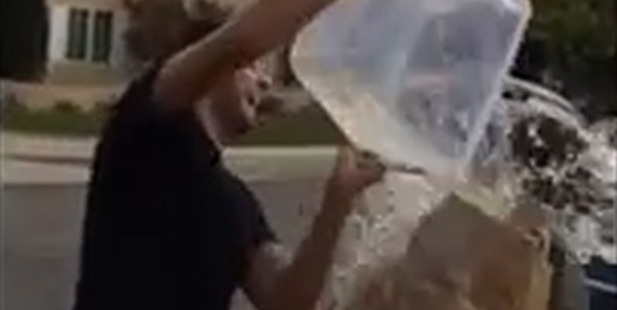 John Krasinski pours cold water over his wife in a surprise version of the celebrity ice bucket challenge. Photo/YouTube