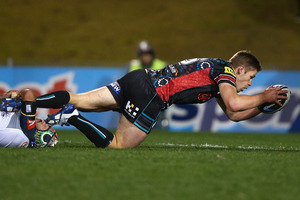 Johnathan Thurston of the Cowboys tackles Jeremy Latimore of the Panthers as he heads to the try line. Photo / Getty Images