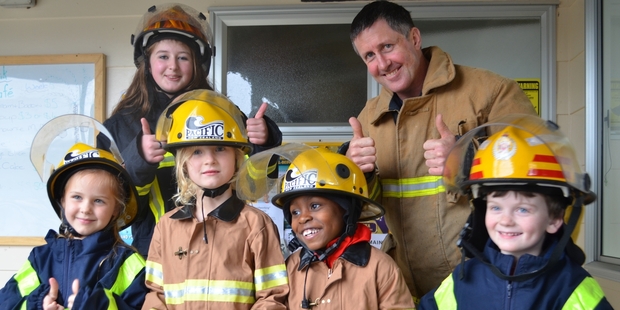 Four young Springbank School pupils won a ride on a fire engine, and a chance to dress up in firefighting uniforms, after entering a colouring competition raising money for the Blood and Leukemia Foundation. The winners, from left, were Millie Stovell (6), Heidi Traas (7), Dexter Badger (6) and Daniel Sutcliffe (6). With them are firefighters Charlotte Stanley-Scott and Tony Scott.