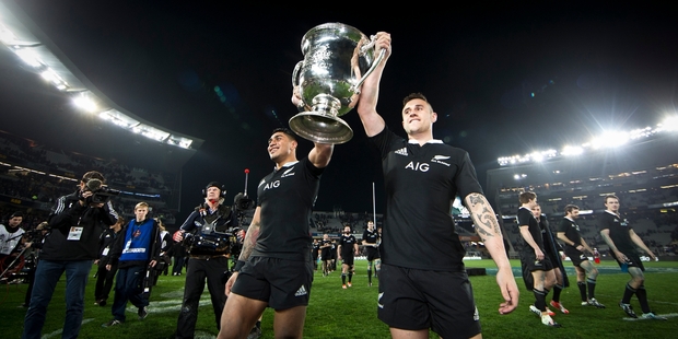 All Blacks Malakai Fekitoa and TJ Perenara carry the Bledisloe Cup, secured for another year. Photo / Greg Bowker
