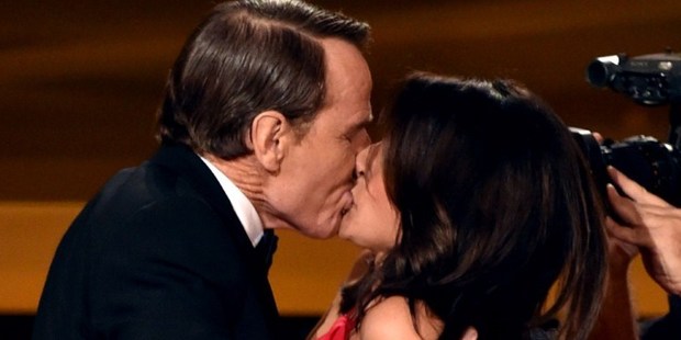 Actress Julia Louis-Dreyfus (right) wins Outstanding Lead Actress in a Comedy Series for 'Veep' and kisses actor Bryan Cranston (left) onstage at the Emmys. Photo / AFP