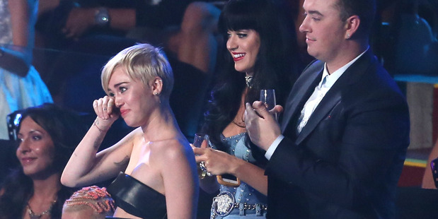 Miley Cyrus, left, tears-up as Jesse accepts the award for Video of the Year on her behalf at the MTV Video Music Awards. Photo / AP
