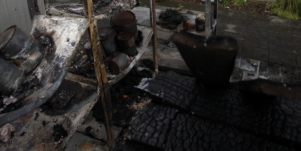 GUTTED: The charred remains of the small shed - the intense heat caused scorching to the wall of the house. PHOTO/PAUL TAYLOR HBT14334204