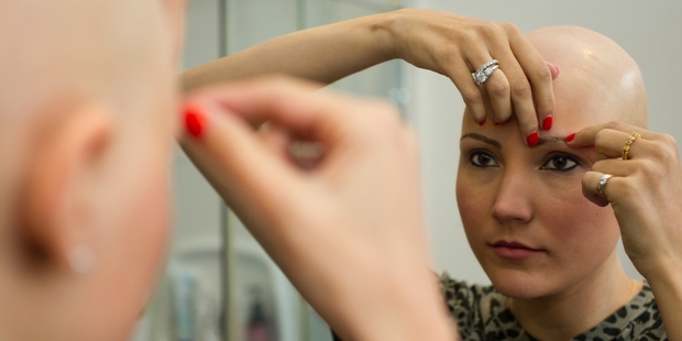 Model Anna Reeve, who lost all her hair to alopecia, tries out the eyebrow wig. Photo / Kellie Blizard