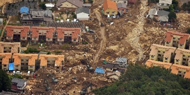 Rescuers search through landslide debris in Hiroshima. Photo / AP