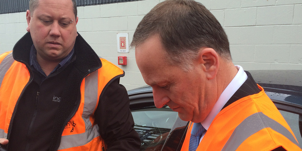 Mr Key signs bottles of Prospect chardonnay for the company to sell as charity fundraisers. Photo / Claire Trevett