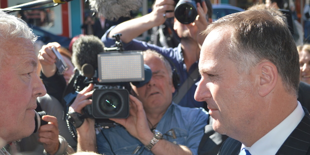 Prime Minister John Key faces off with Bernie Monk in Greymouth. Photo / Greymouth Star