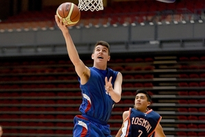 Zack Te Puni of Rangitoto College finishes at the hoop against Rosmini College during the semifinals of the Junior Secondary School Zone 1/2 Premierships at ASB Arena. PHOTOS/GEORGE NOVAK