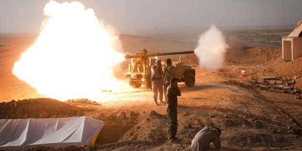 Iraqi Kurdish Peshmerga fighters fire towards Islamic State (IS) positions during heavy clashes in Tuz Khurmatu in Salaheddin province. Photo / AP