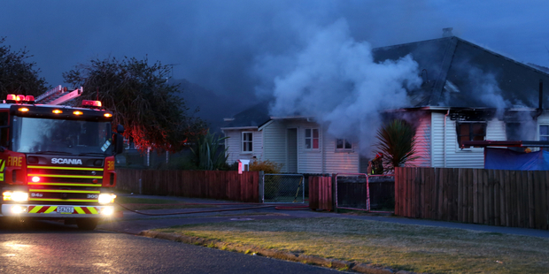 An occupant suffering injuries after a house fire in Rotorua. Photo / SNPA / Peter Graney