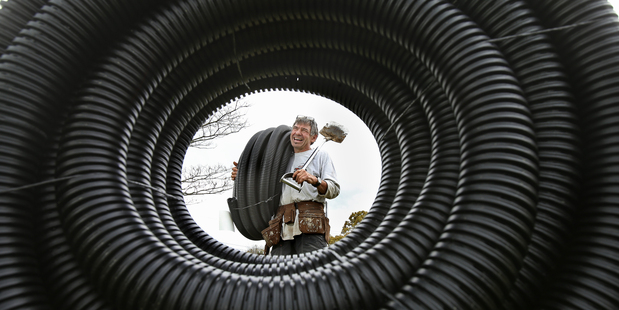 A community garden is being built in the Bethlehem Community Church grounds on Moffat Rd. Al Gourley with some drainage pipe that will be used in the gardens. Photo / John Borren
