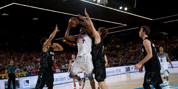 Kenneth Faried of the U.S, duels of the ball in front New Zealand's Tai Webster, left, and Rob Loe, second right, during the Group C Basketball World Cup match, in Bilbao. Photo / AP