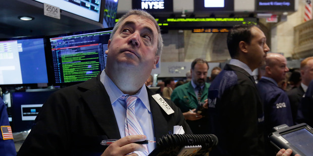 Trader Edward McCarthy, left, works on the floor of the New York Stock Exchange. File photo / AP