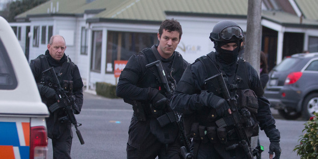 Police Armed Offenders Squad members returning to the Ashburton Police Station after apprehending armed fugitive Russell John Tully. 1 September 2014 New Zealand Herald Photograph by Mark Mitchell.