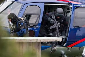 AOS members exit a helicopter in Ashburton. Photo / Martin Hunter