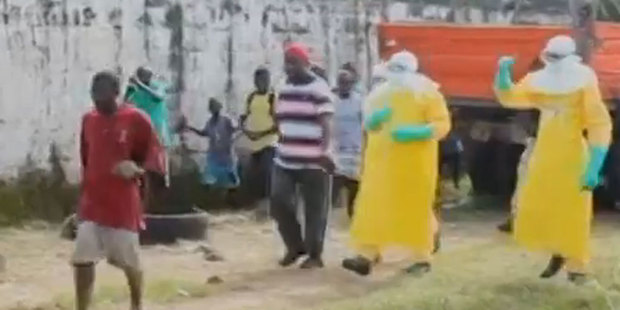 The man in red can be seen wearing a white tag - showing he has tested positive for Ebola. Photo / still from video
