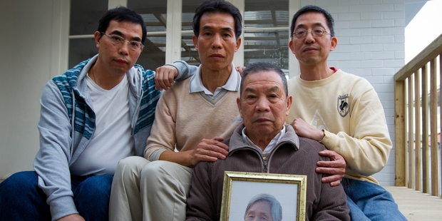 Ri Dong Liu holds a picture of Jie Rong Luo. Behind him are sons, from left, Guo Xiong Liu, Chi Hong Lao and Sui Xiong Liu. Photo / Jason Oxenham