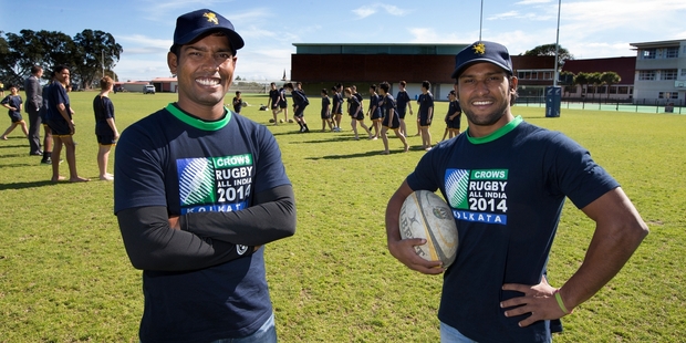Nanda Majhi (left) and Tiger Ahmed get a taste of rugby Auckland-style. Picture / Brett Phibbs