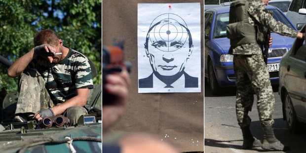 A pro-Russian fighter rests ontop a T-64 tank, Vladimir Putin is used for target practice and cars are stopped at a checkpoint in Donetsk as residents flee. Photo / AFP