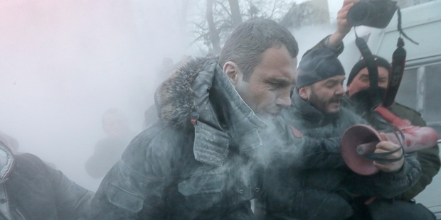Opposition leader Vitali Klitschko is attacked and sprayed with a fire extinguisher as he tries to calm the situation. Photo / AP