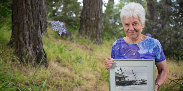 Marie Leadbeater with a photograph of the sunken Rainbow Warrior.