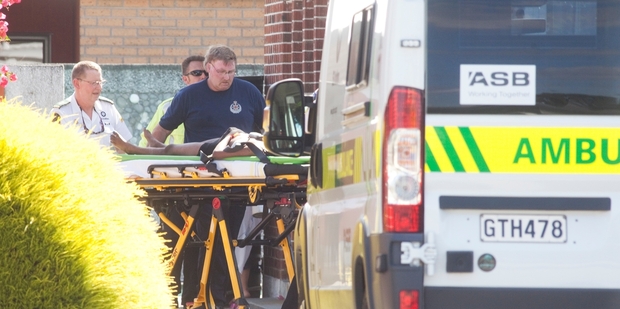 Emergency service staff wheel the girl from the Classic Motel. Photo / Rhys Palmer