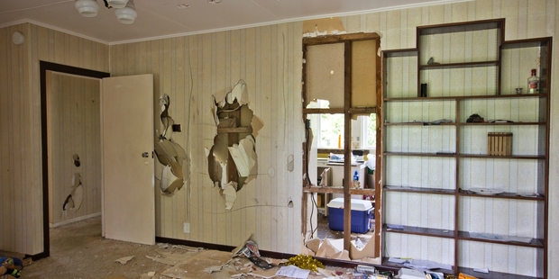 A hole in the wall in the living room of the Forrest Hill house exposes the kitchen. Photo / Greg Bowker