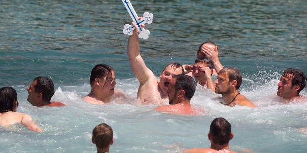 Alexander Zapisetskiy proudly holds the cross aloft. Photo / Natalie Slade
