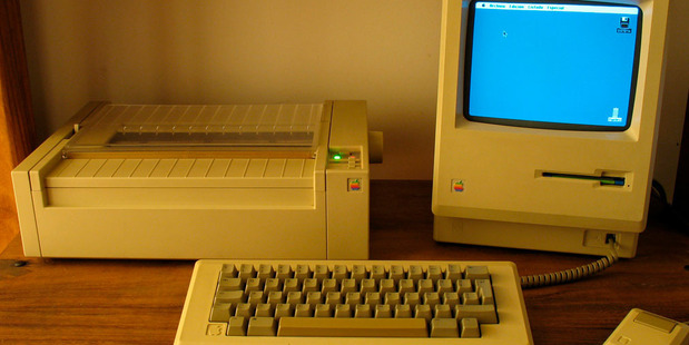 An Apple Macintosh 512K (also called a Fat Mac) with its original mouse and keyboard, next to an Apple ImageWriter I dot-matrix printer. Photo / Guillermo Esteves/Wikimedia Commons.