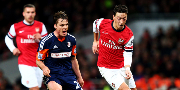Mesut Oezil of Arsenal evades Scott Parker of Fulham during the Barclays Premier League match between Arsenal and Fulham. Photo / AP