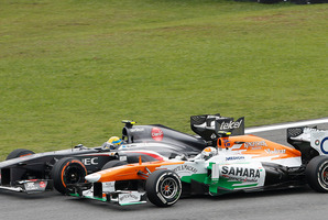 Sauber driver Esteban Gutierrez of Mexico, left, overtakes Force India driver Adrian Sutil of Germany, during the 2013 Brazilian Formula One Grand Prix. Photo / AP