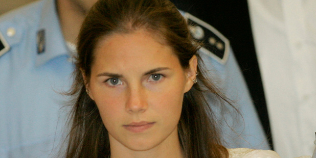 Amanda Knox is escorted by Italian penitentiary police officers from Perugia's court. Photo / AP