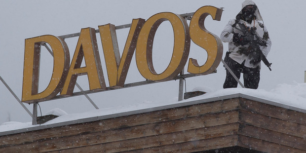 A police officer stands on the roof of a hotel next to the Congress Center in Davos, Switzerland. A new survey shows the world's CEOs are 'gradually switching from survival mode to growth mode'. Photo / AP