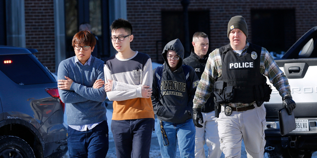 Police evacuate students from the Electrical Engineering building after shots were fired. Photo / AP